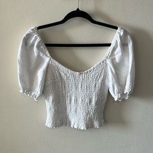 White, Cropped top with sleeves.